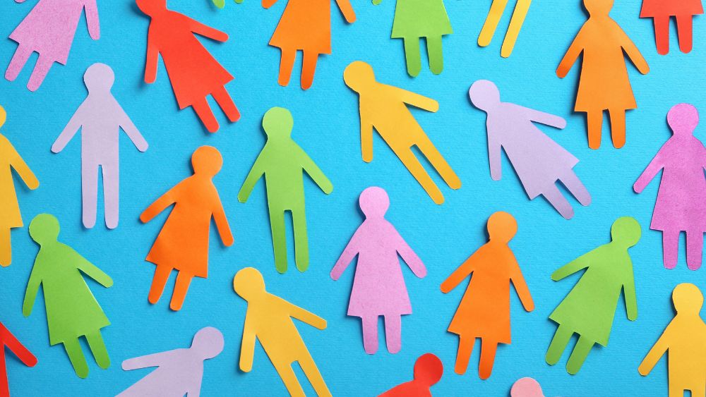 Paper cut outs of people in lots of different colours, representing diversity