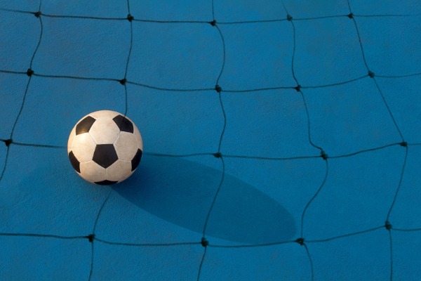 How does football raise money for charity?